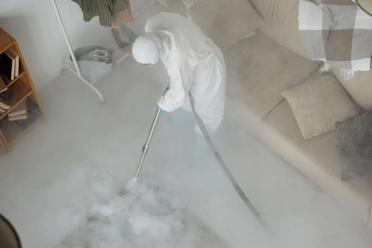 Biohazard cleanup technician in protective equipment, Mountainair, NM